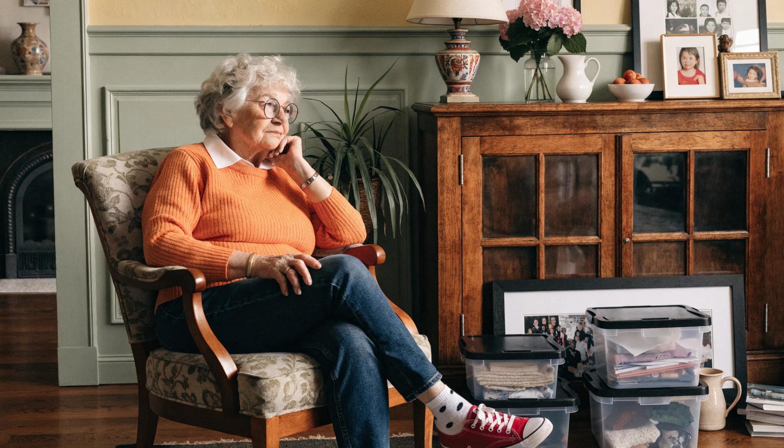 Senior woman reflecting on emotional adjustments during downsizing